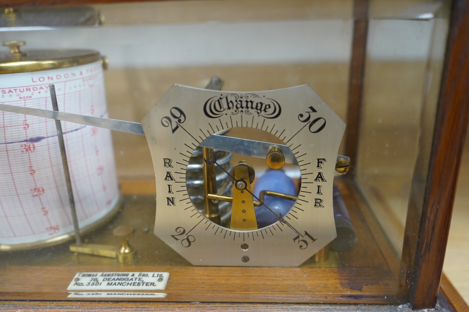 An oak cased barograph with integral barometer by Thomas Armstrong & Bro. Ltd. 78 Deansgate, Manchester, with bevelled glass panels and drawer to base, 37cm wide, 23cm deep, 22cm high. Condition - good, untested.